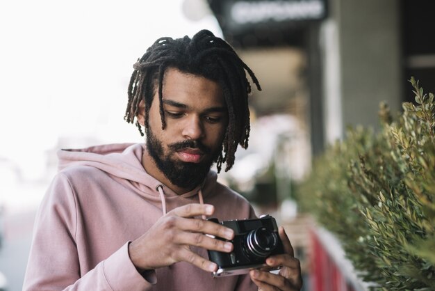 Handsome man holding camera medium shot