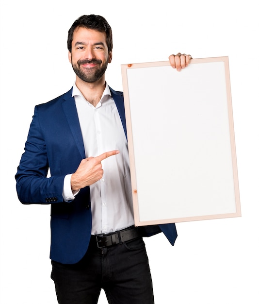 Free photo handsome man holding an empty placard