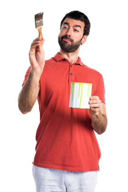 Handsome man holding a paint pot