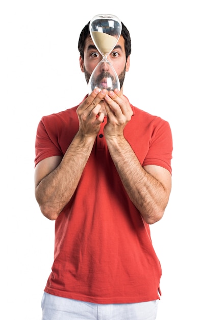 Free Photo handsome man holding a vintage sand clock