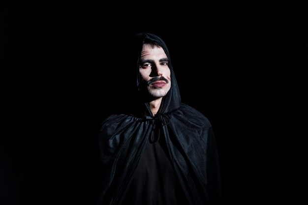 Free Photo handsome man in hooded cape