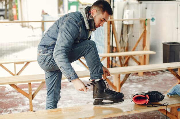 Handsome man in a ice arena with skate