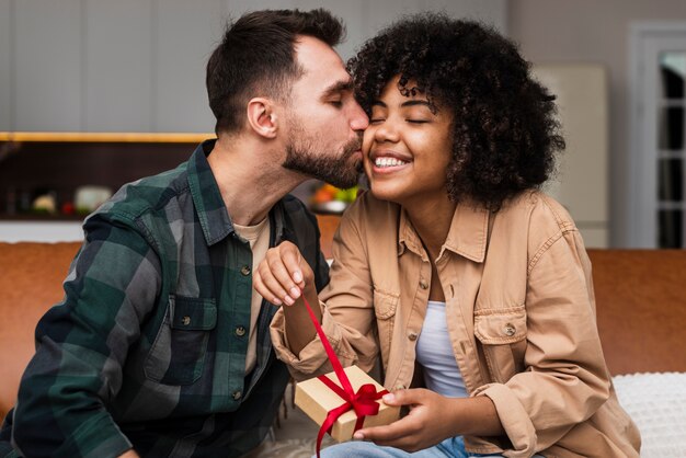 Handsome man kissing beautiful woman