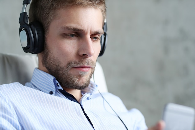 Free Photo handsome man listening music on headphones