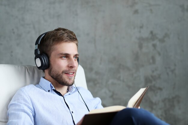 Handsome man listening music on headphones