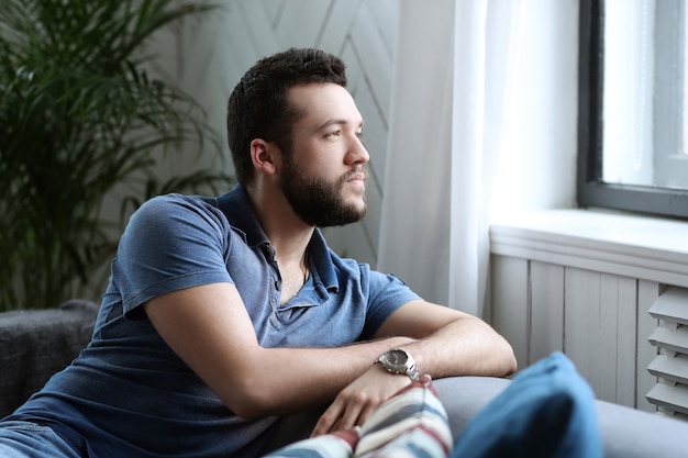 Handsome man looking at window from the coach