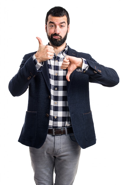 Handsome man making good-bad sign