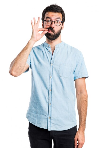 Handsome man making silence gesture