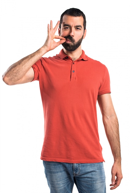 Handsome man making silence gesture