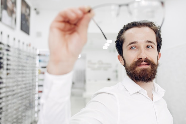 Free Photo handsome man in a optics shop