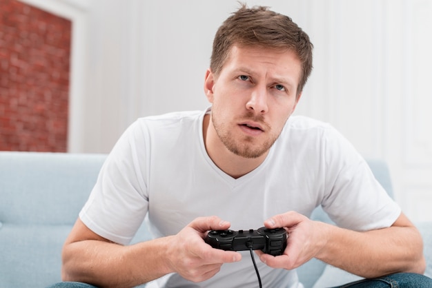 Handsome man playing a game with a controller