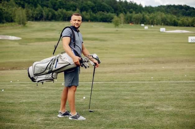 Handsome man playing golf on a golf course