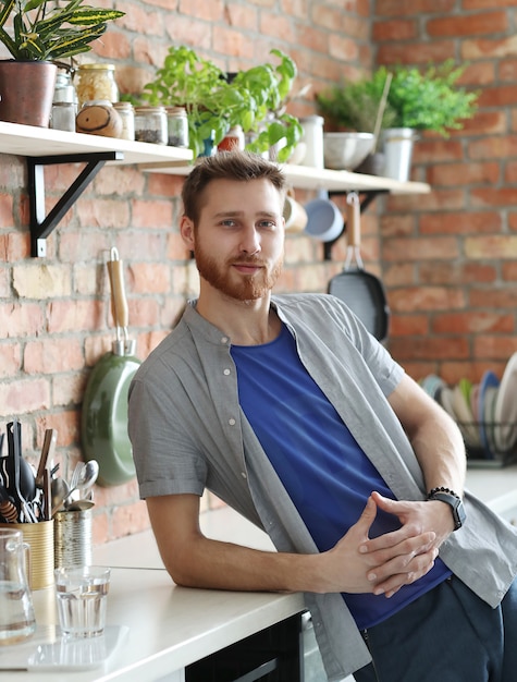 Handsome man posing in kitchen