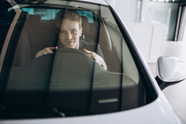 Handsome man sitting in car