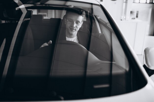 Handsome man sitting in car