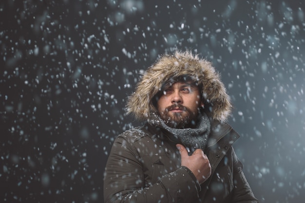 Handsome man in snow storm