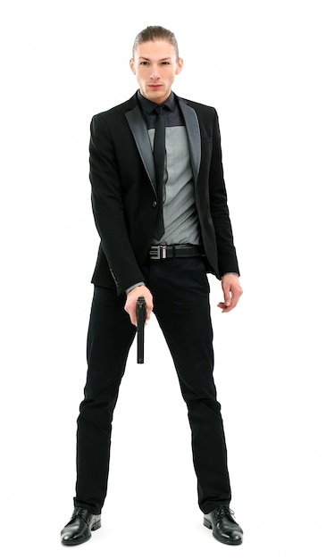 Free photo handsome man in a suit with gun