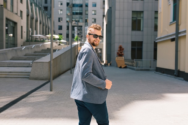 Free Photo handsome man in sunglasses walking on street