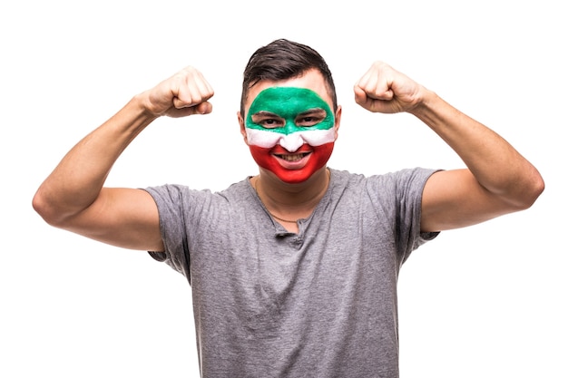 Free Photo handsome man supporter fan of iran national team painted flag face get happy victory screaming into a camera. fans emotions.