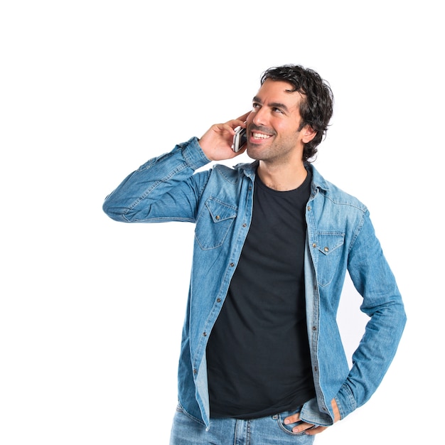 Handsome man talking to mobile over white background