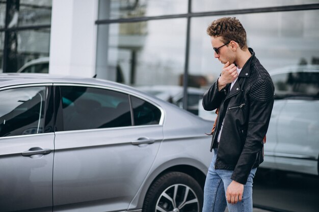 Handsome man tourist buying a car