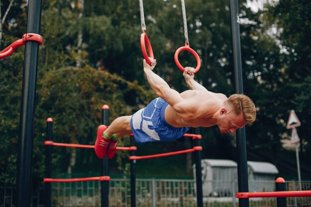 Handsome man training in a summer park