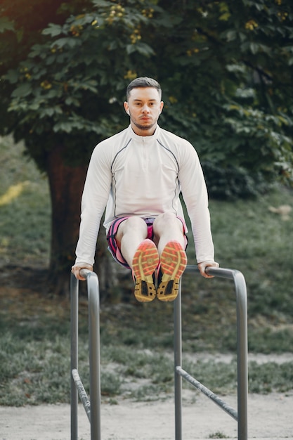 Free photo handsome man training in a summer park