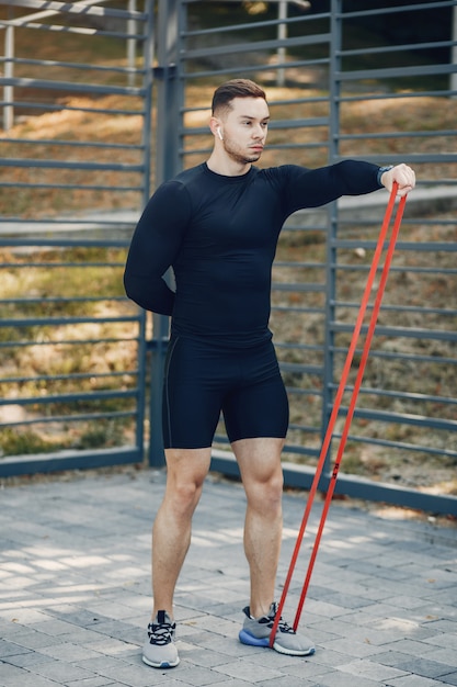 Handsome man training in a summer park