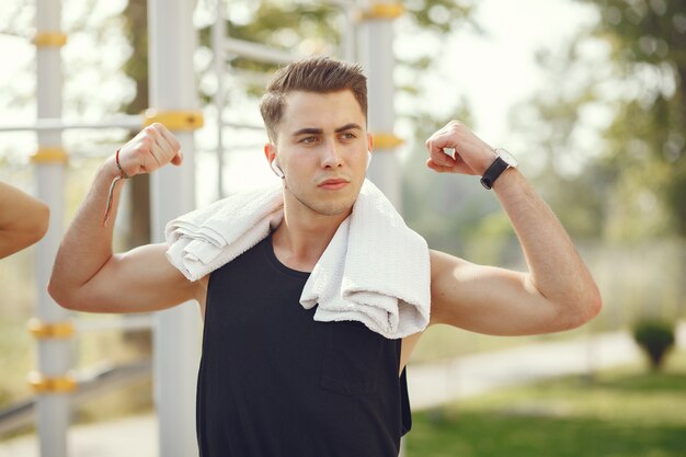 Handsome man training in a summer park