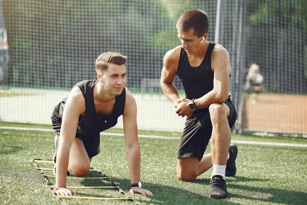 Handsome man training in a summer park