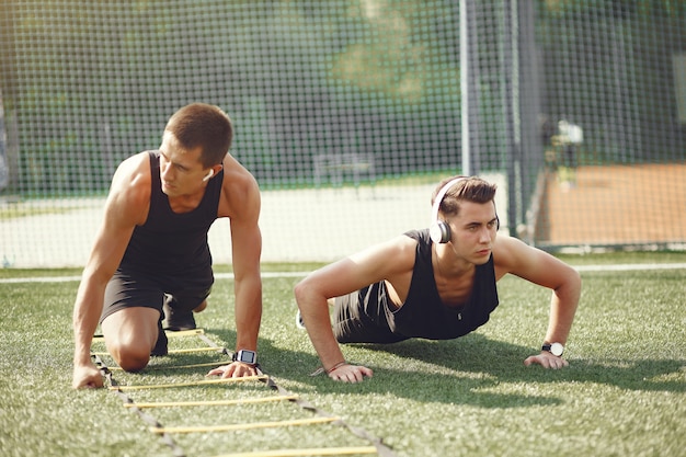 Handsome man training in a summer park