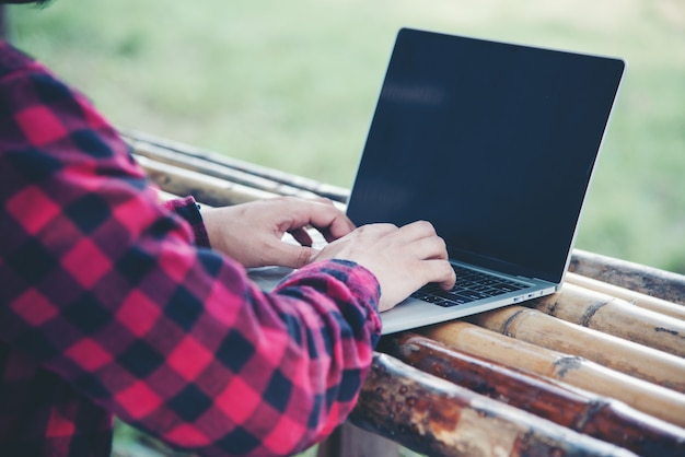 Handsome man using laptop in the travel nature