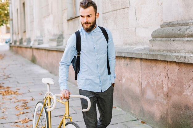 Handsome man walking bike