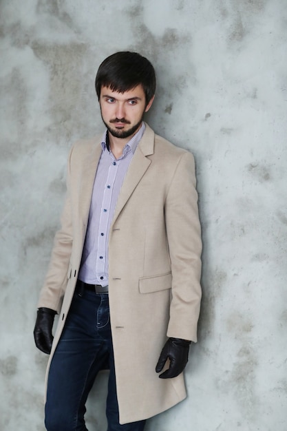 Free Photo handsome man wearing beige coat