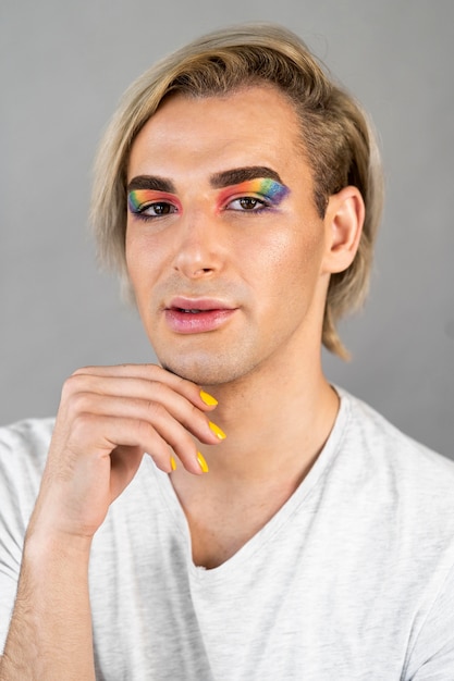 Handsome man wearing make-up cosmetics and nail polish