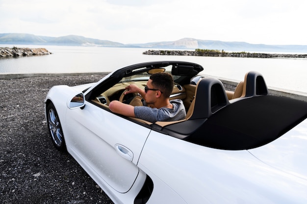 Handsome man in white car