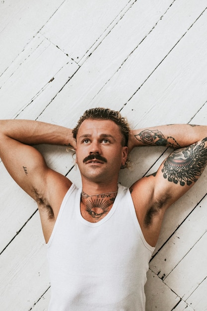 Free photo handsome man in white tank top fashion shot