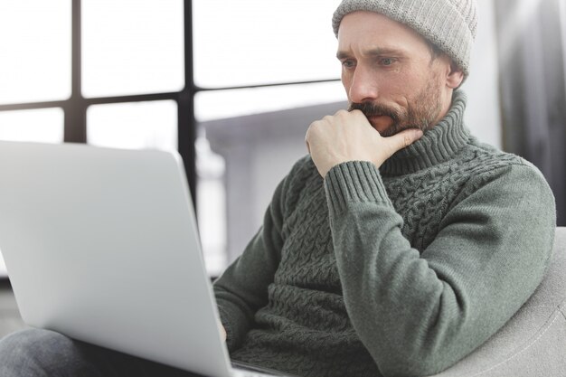 Handsome man with beard and laptop