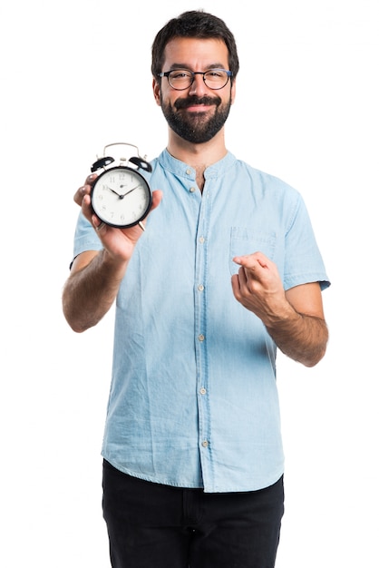 Handsome man with blue glasses holding clock