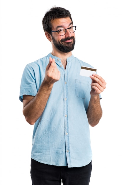 Handsome man with blue glasses holding a credit card