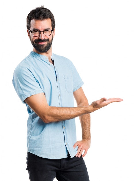 Handsome man with blue glasses presenting something