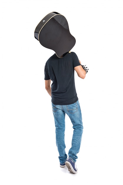 Handsome man with guitar over white background