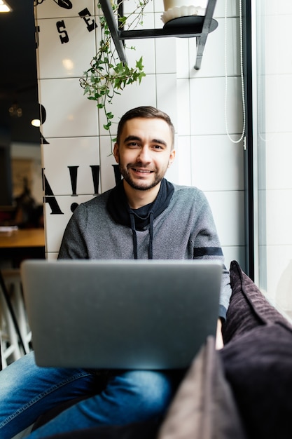 Handsome man with laptop in a cafe