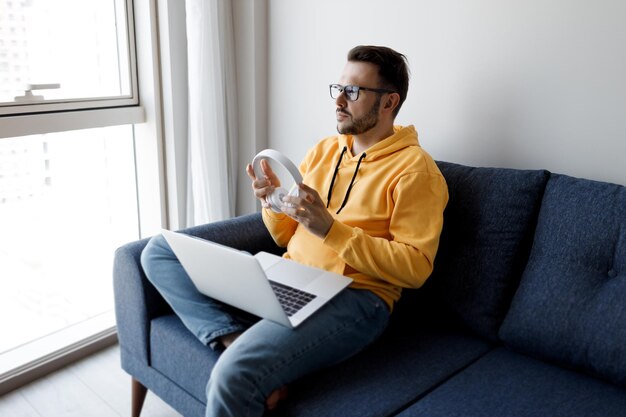 Free photo handsome man with laptop at home