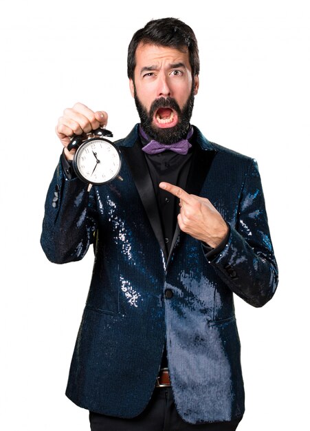 Handsome man with sequin jacket holding vintage clock