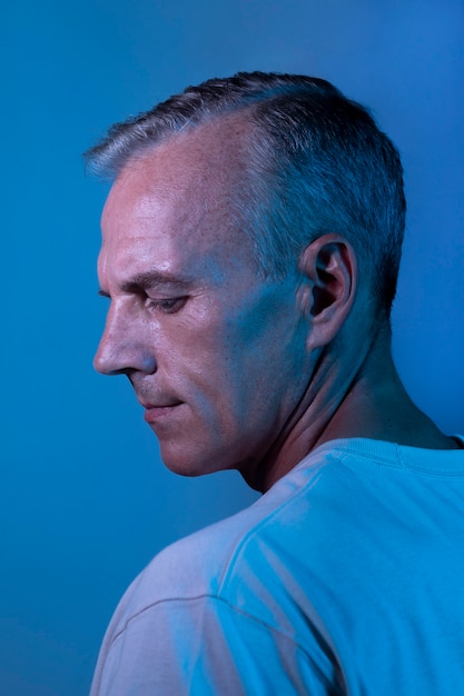 Handsome middle aged man portrait in neon lights