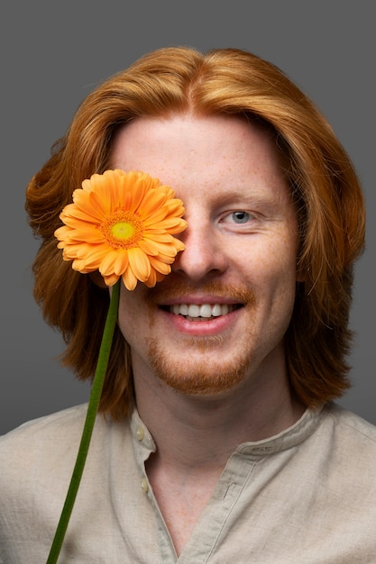 Handsome and sensitive man with flower