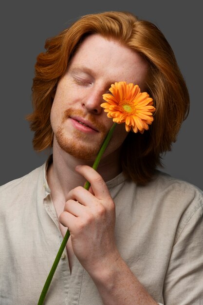 Handsome and sensitive man with flower