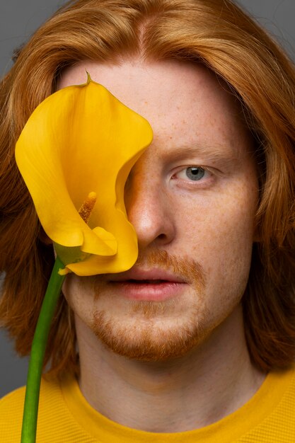 Handsome and sensitive man with flower