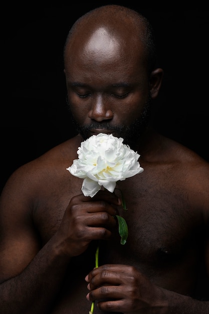 Handsome and sensitive man with flower